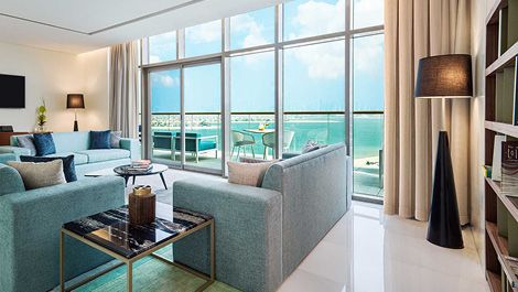 Living room with beach view at Th8 Palm Dubai Beach Resort